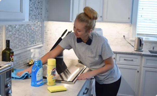 a cleaning expert from arrow cleaning solution cleaning the kitchen