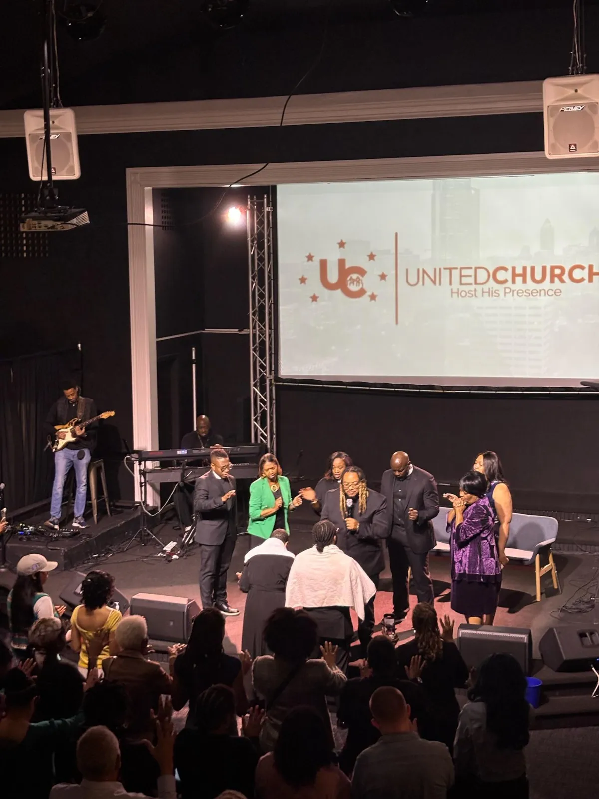 people sitting on chair in front of table while holding pens during daytime