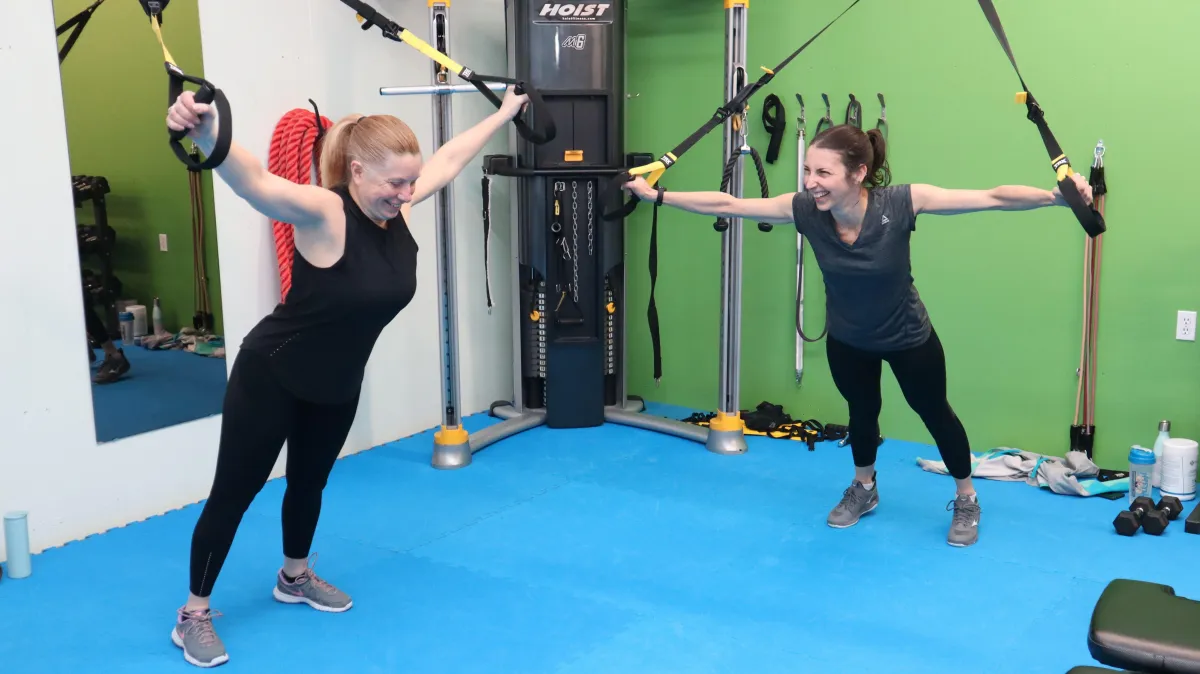 group of women exercise using dumbbells