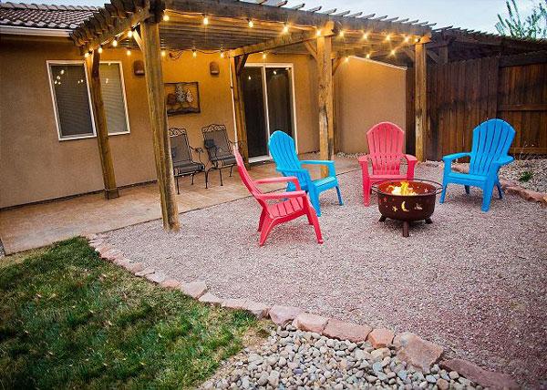 backyard with chairs around fire pit