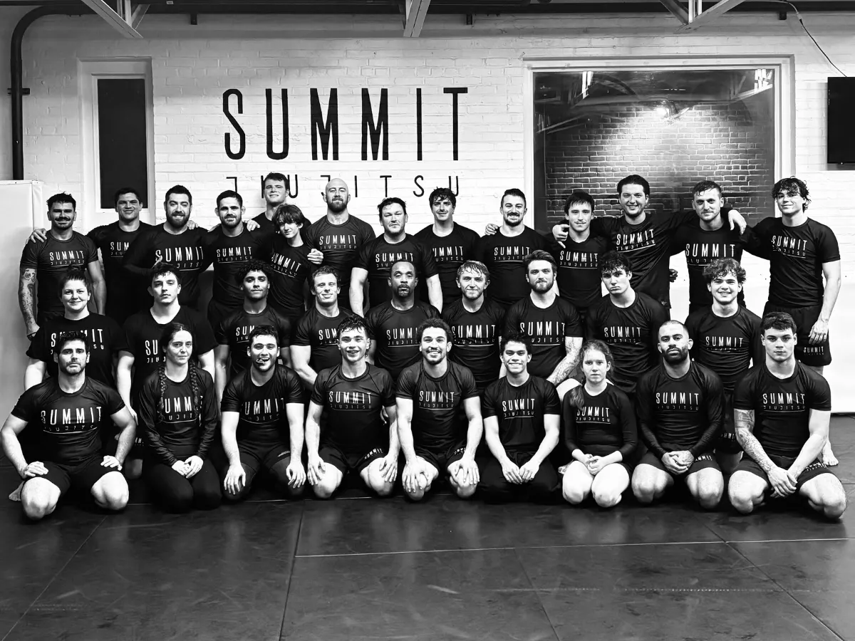 Team of diverse adults training Brazilian Jiu-Jitsu together in a supportive environment