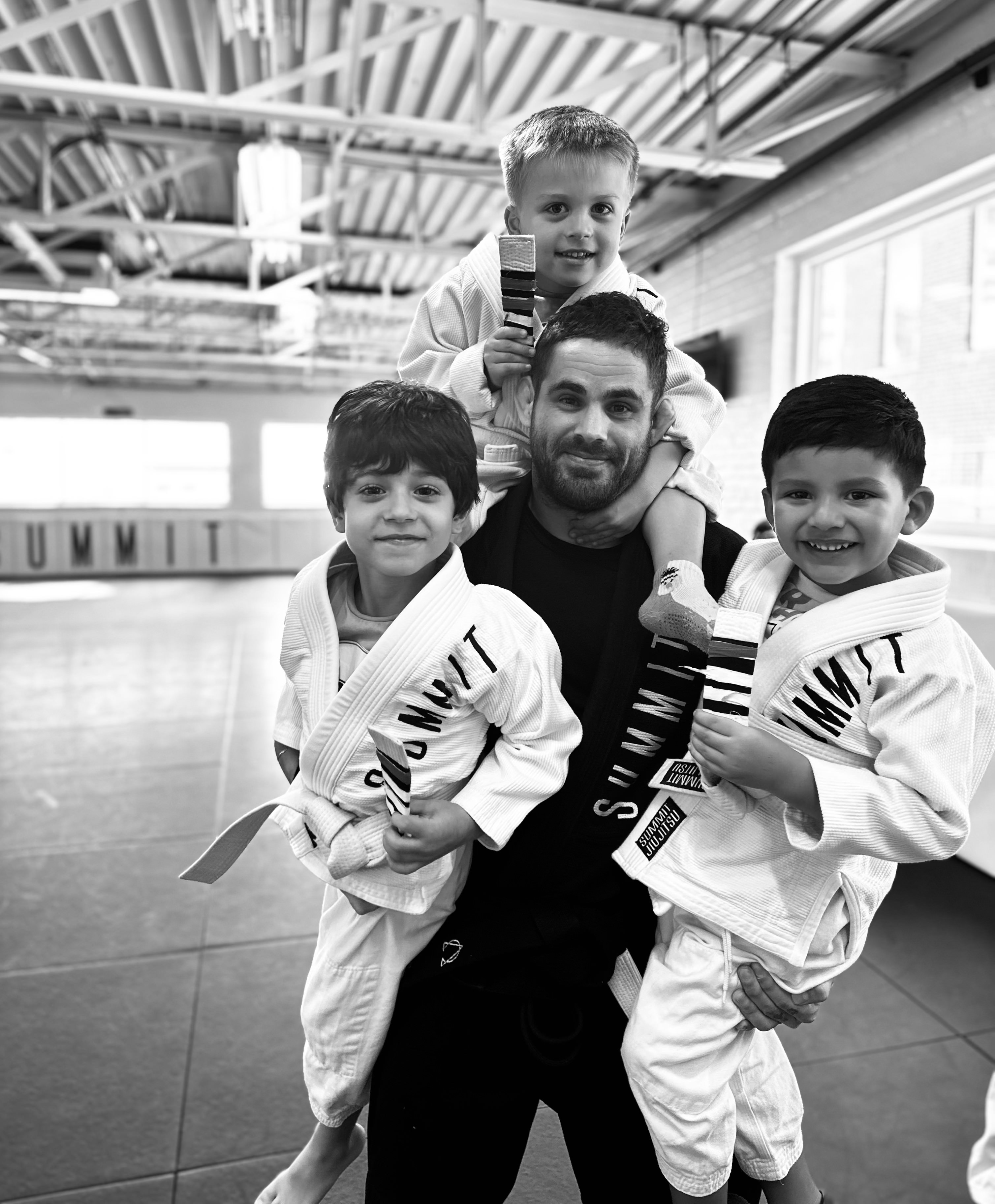 Kids drilling Brazilian Jiu-Jitsu techniques in a focused environment