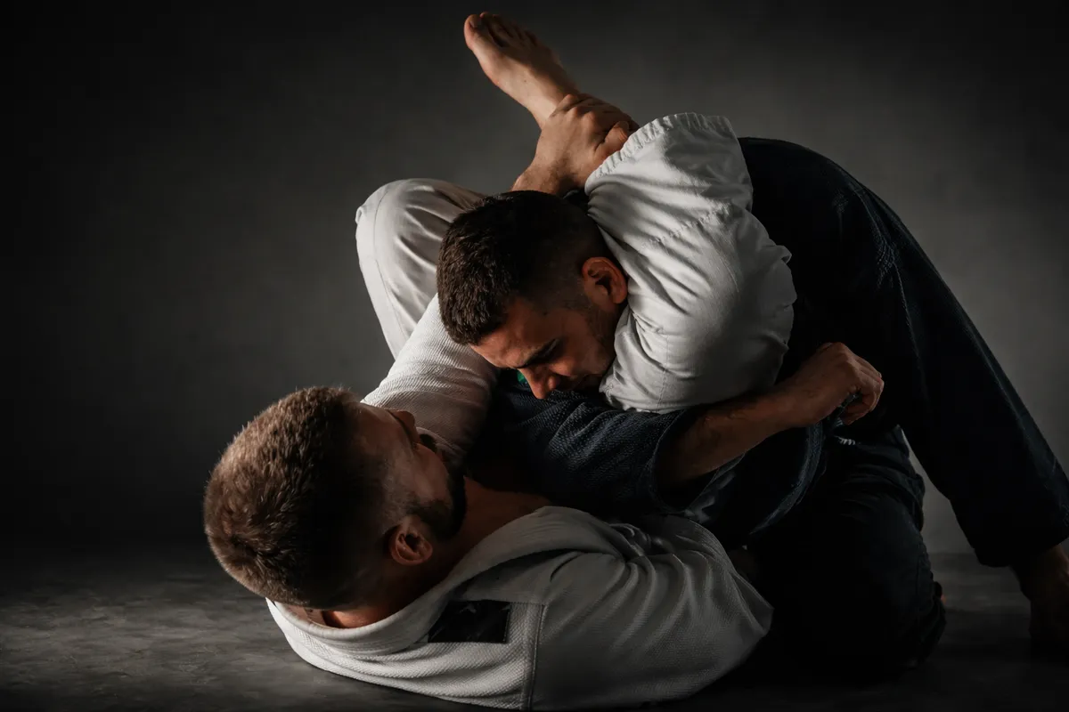 Brazilian Jiu-Jitsu practitioners practicing a grappling technique