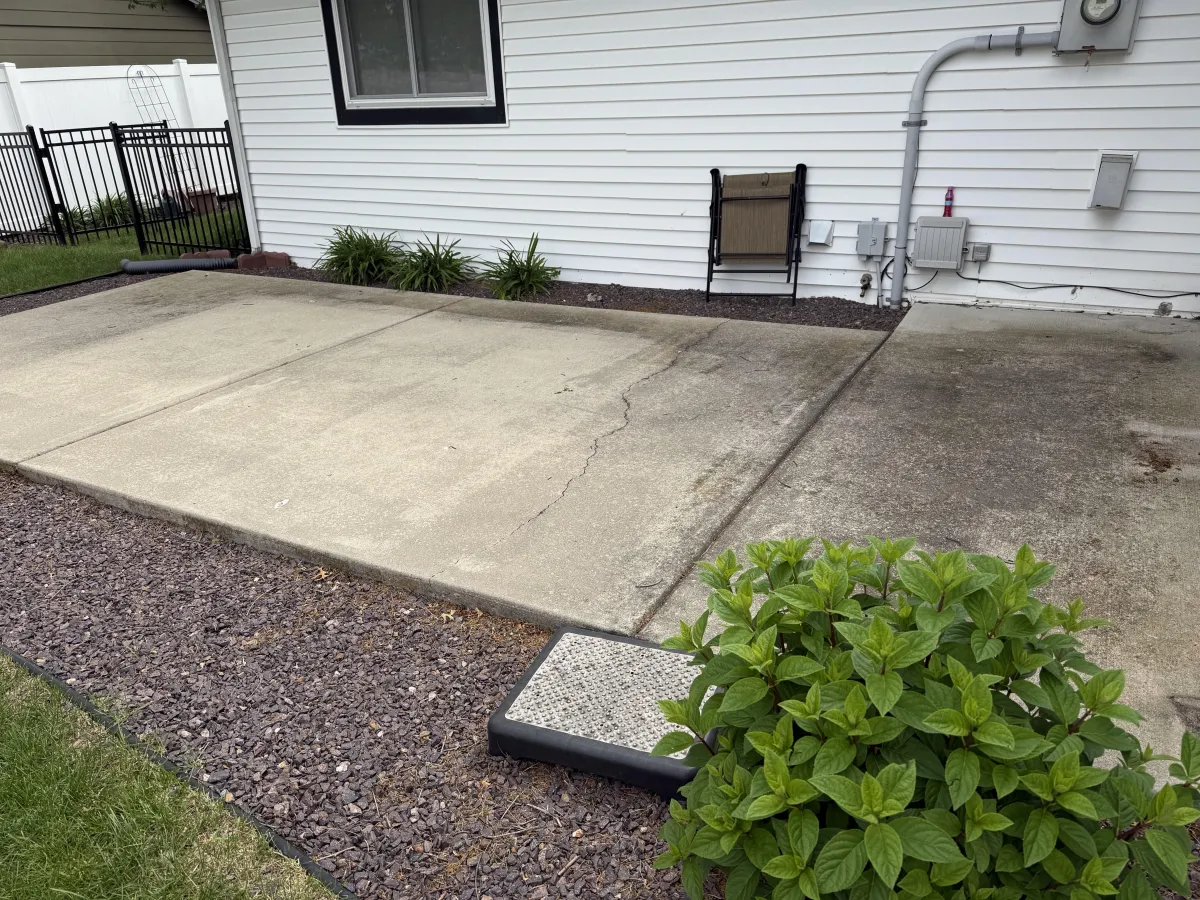 Dirty patio surface with grime and algae buildup