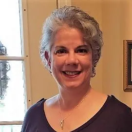 short-haired black cat besides brown wooden table