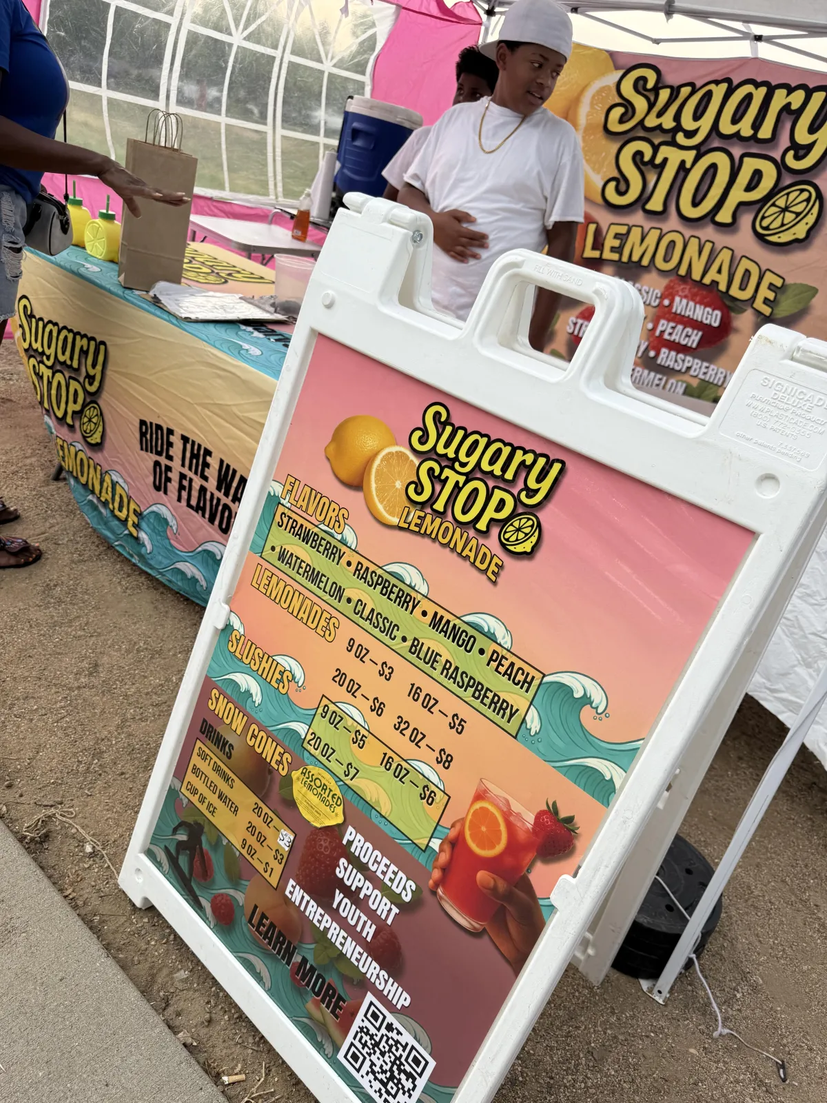Modern Sugary Stop food trailer parked at a community pop-up, clean and welcoming, photographed in an authentic documentary style.