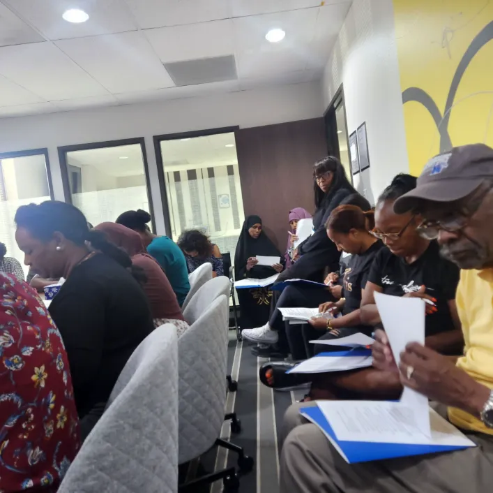 Community members engaged in a supportive mental health discussion