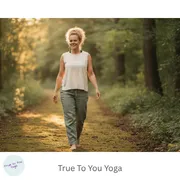 woman walking through forest with peaceful, joyful look on her face