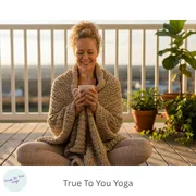 woman sitting on deck drinking tea