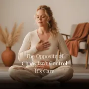woman sitting on floor with one hand on heart and one hand on belly