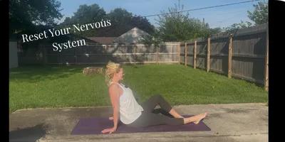 woman sitting on ground with one leg long & one bent