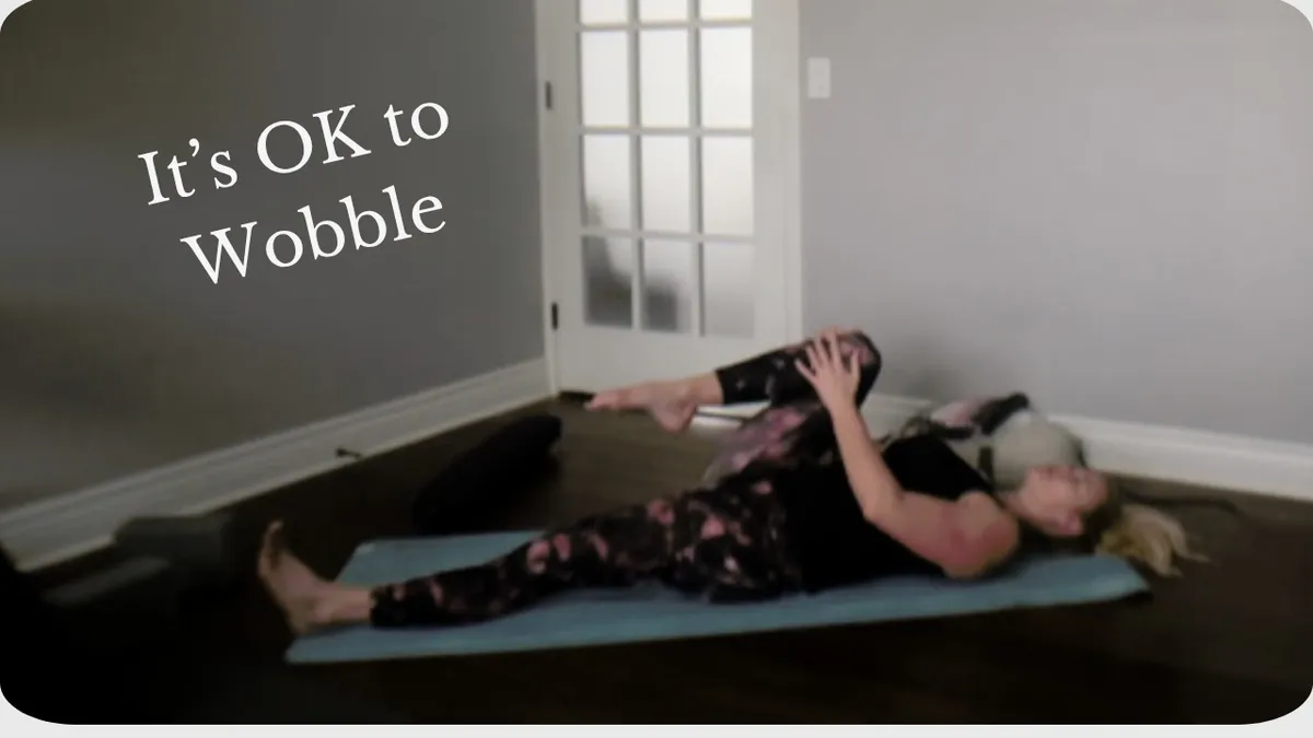 woman laying on floor with one leg drawn into chest