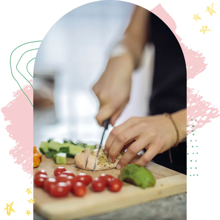 Midlife woman preparing a healthy meal with chicken and fresh vegetables, focusing on hormone-supportive nutrition.
