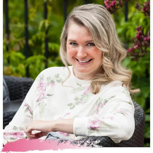 Kimberlee Erin, Certified Menopause Coach and Holistic Nutritionist, smiling while seated in a calm, welcoming space—radiating warmth, confidence, and joy in midlife.