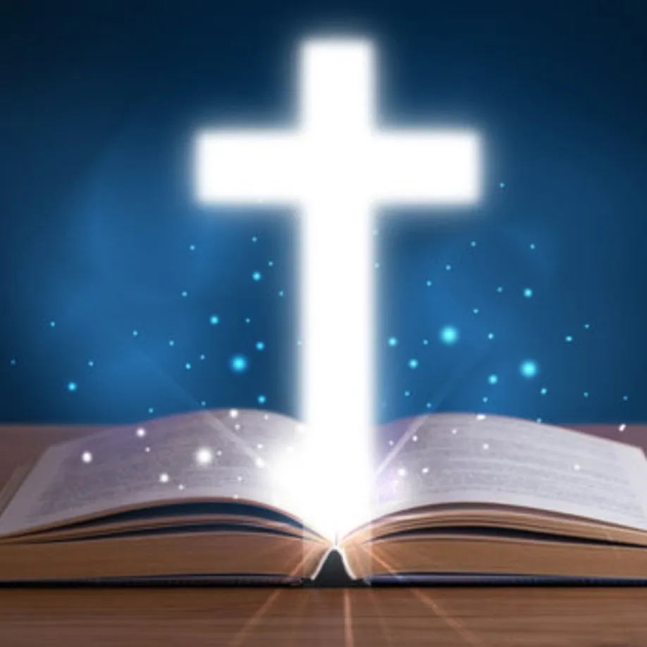 An open Bible with a glowing, radiant cross emerging from its pages. Sparkling light particles surround the cross, creating an ethereal and spiritual atmosphere. The deep blue background adds a sense of depth and reverence to the image, symbolizing divine guidance and enlightenment.