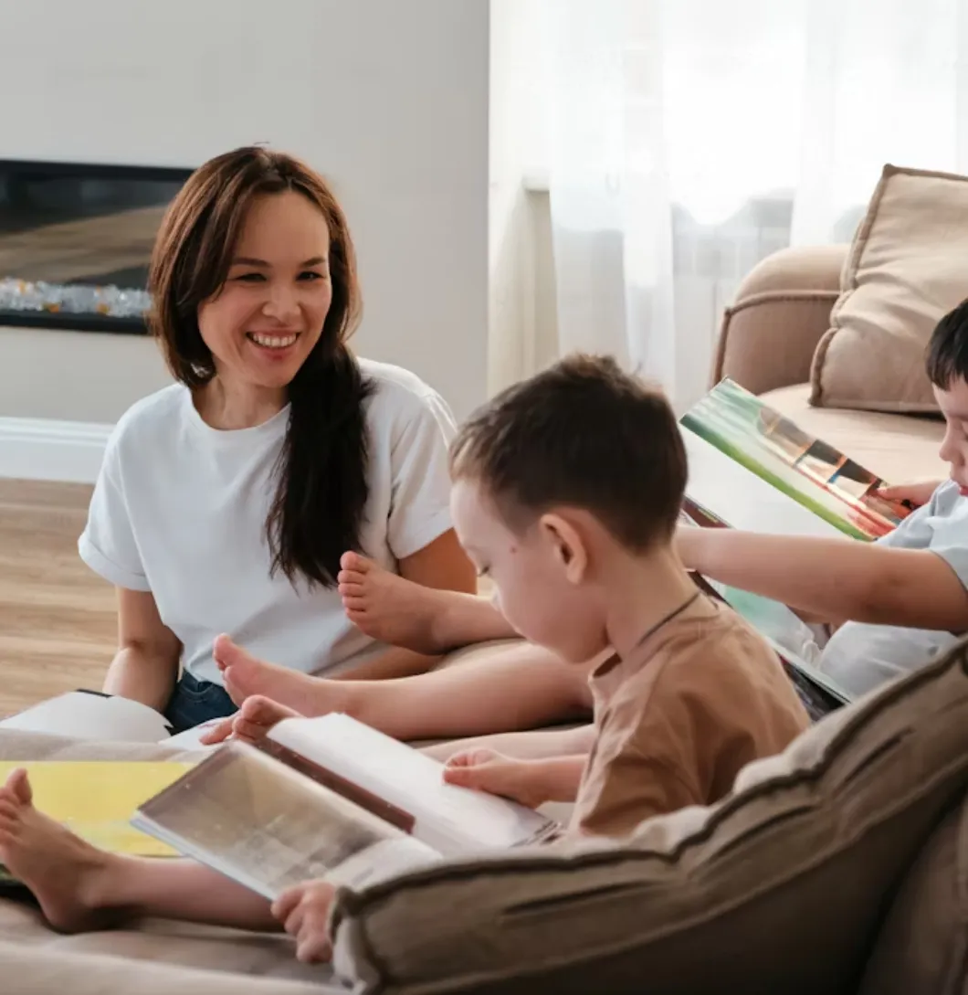 sitter with kids, reading books and taking care of them