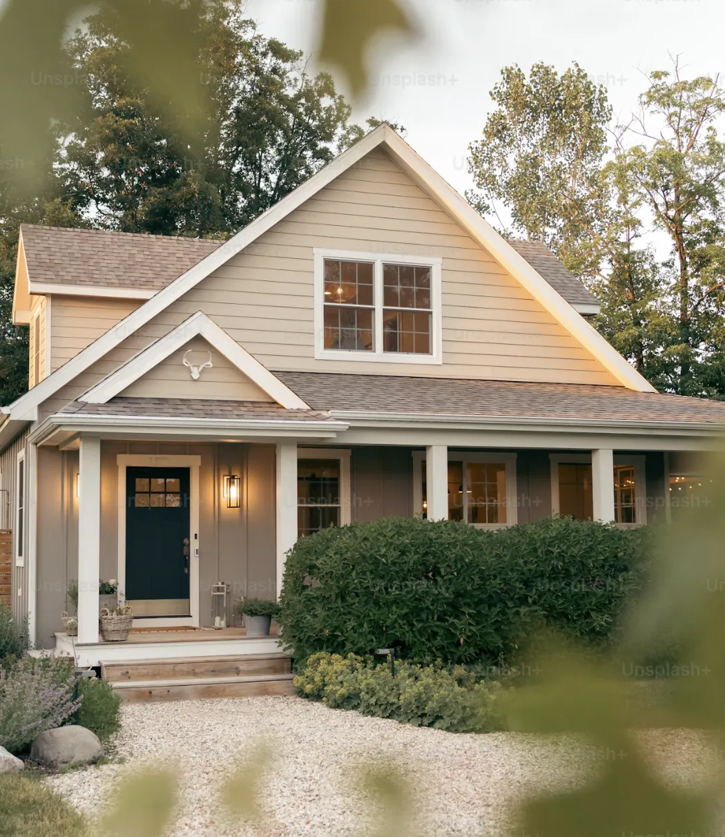 photo of keys in hand of homeowner with a small model house in frame
