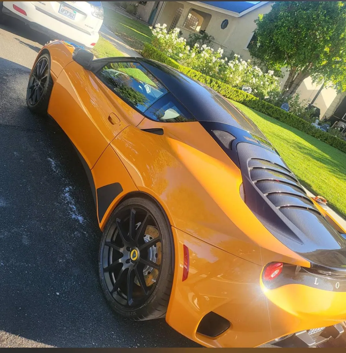 Orange and black Lotus Evora parked in a residential neighborhood after luxury mobile detail service in Los Angeles