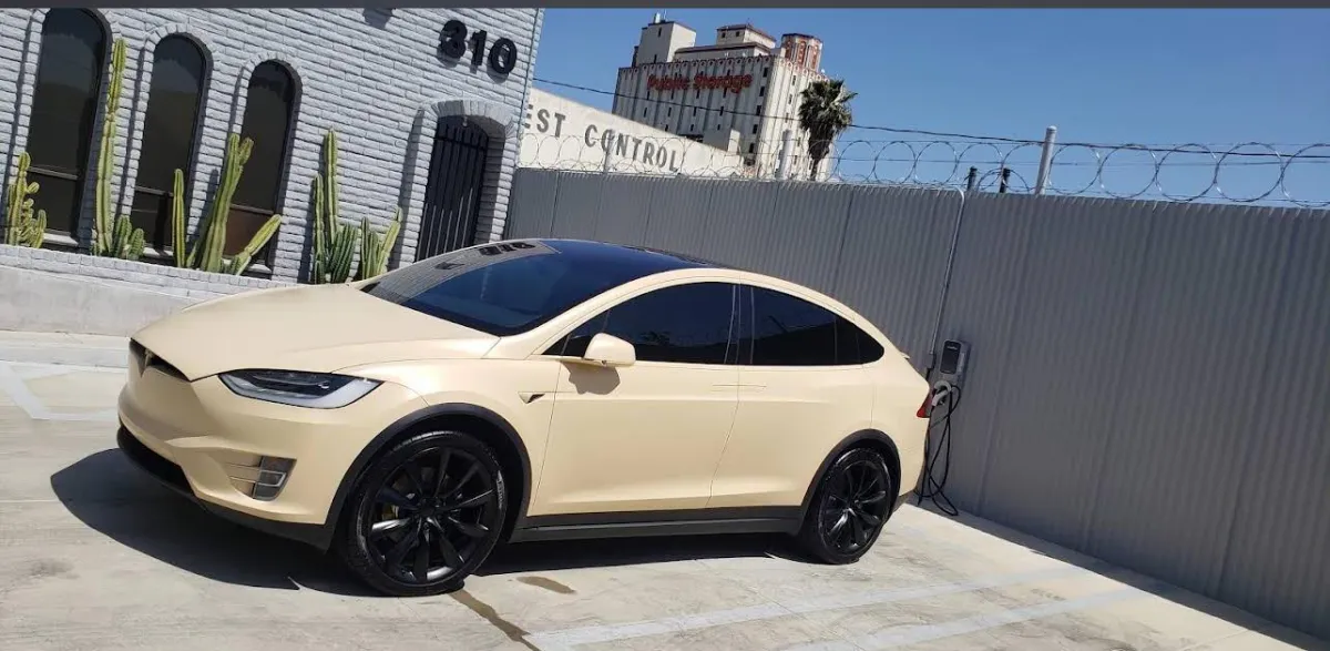 Matte cream Tesla Model X freshly detailed in Los Angeles with black wheels and clean glass finish