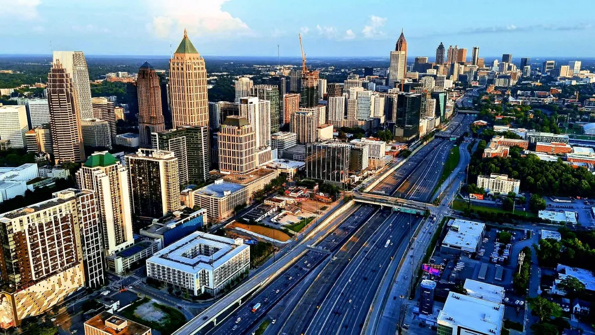 Aerial drone view of downtown Atlanta, Georgia with skyscrapers, highways, and city skyline.