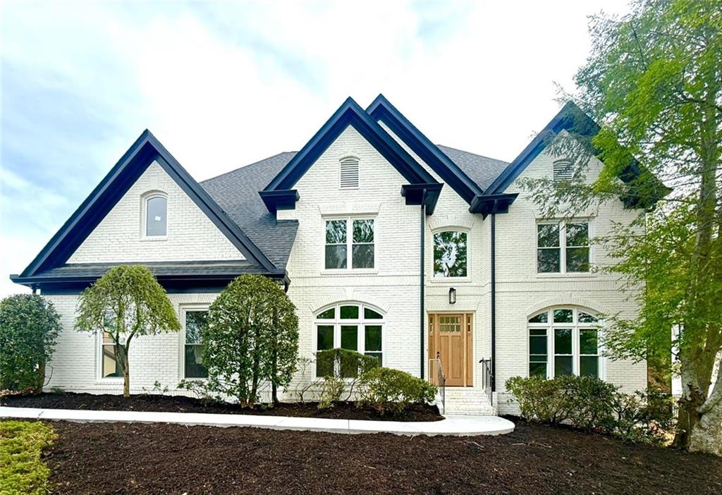 Medlock Bridge Brick house painted white brick in Johns Creek