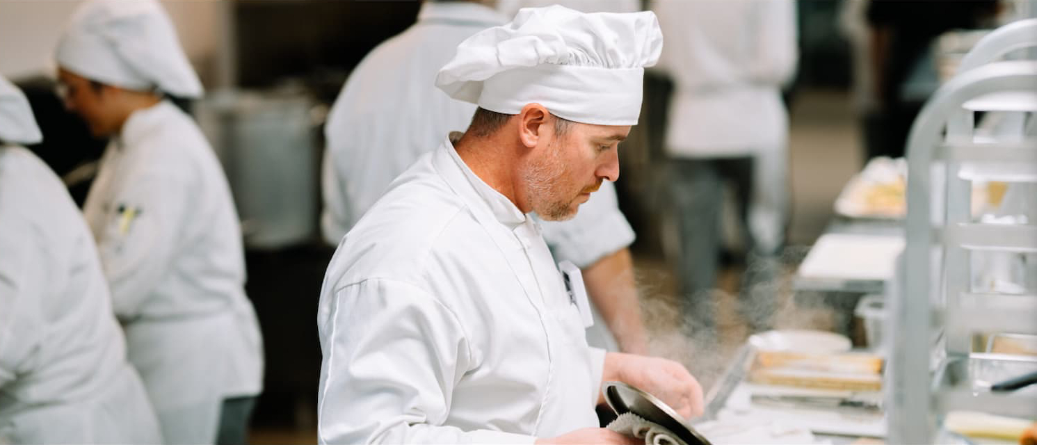 Culinary graduate working in a professional kitchen