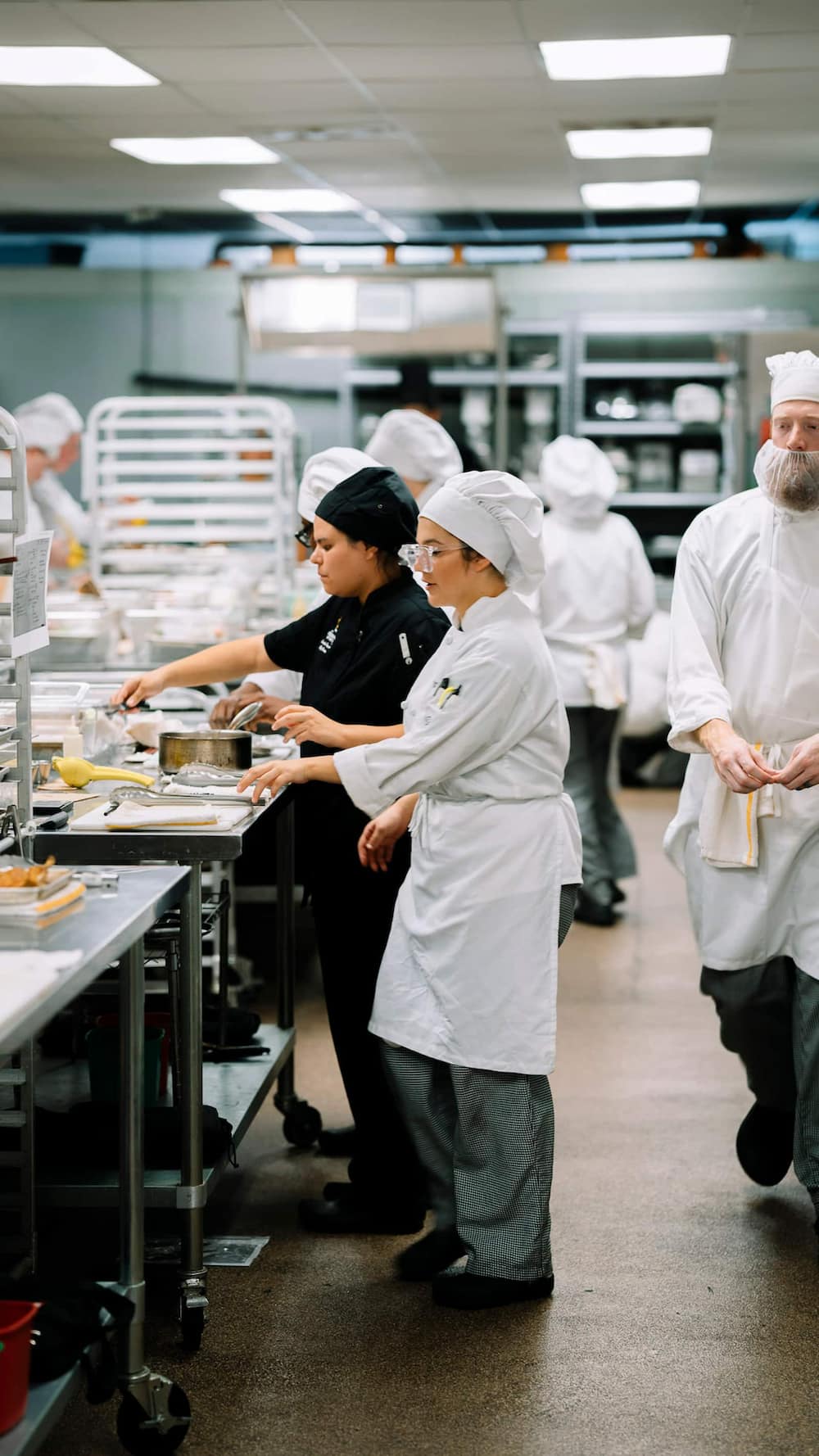 Culinary student practicing professional cooking techniques