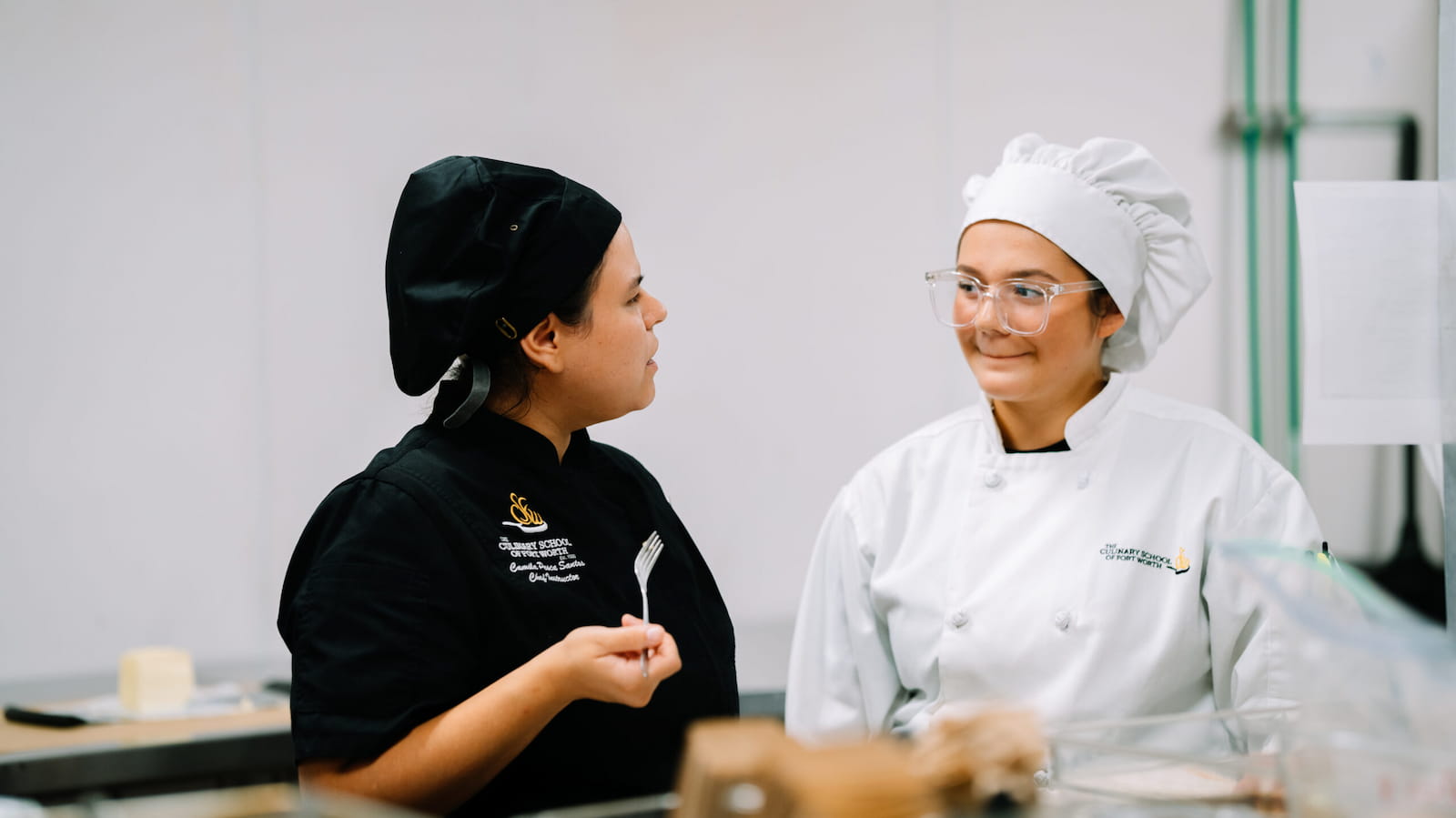 Culinary student preparing food in a Fort Worth restaurant kitchen