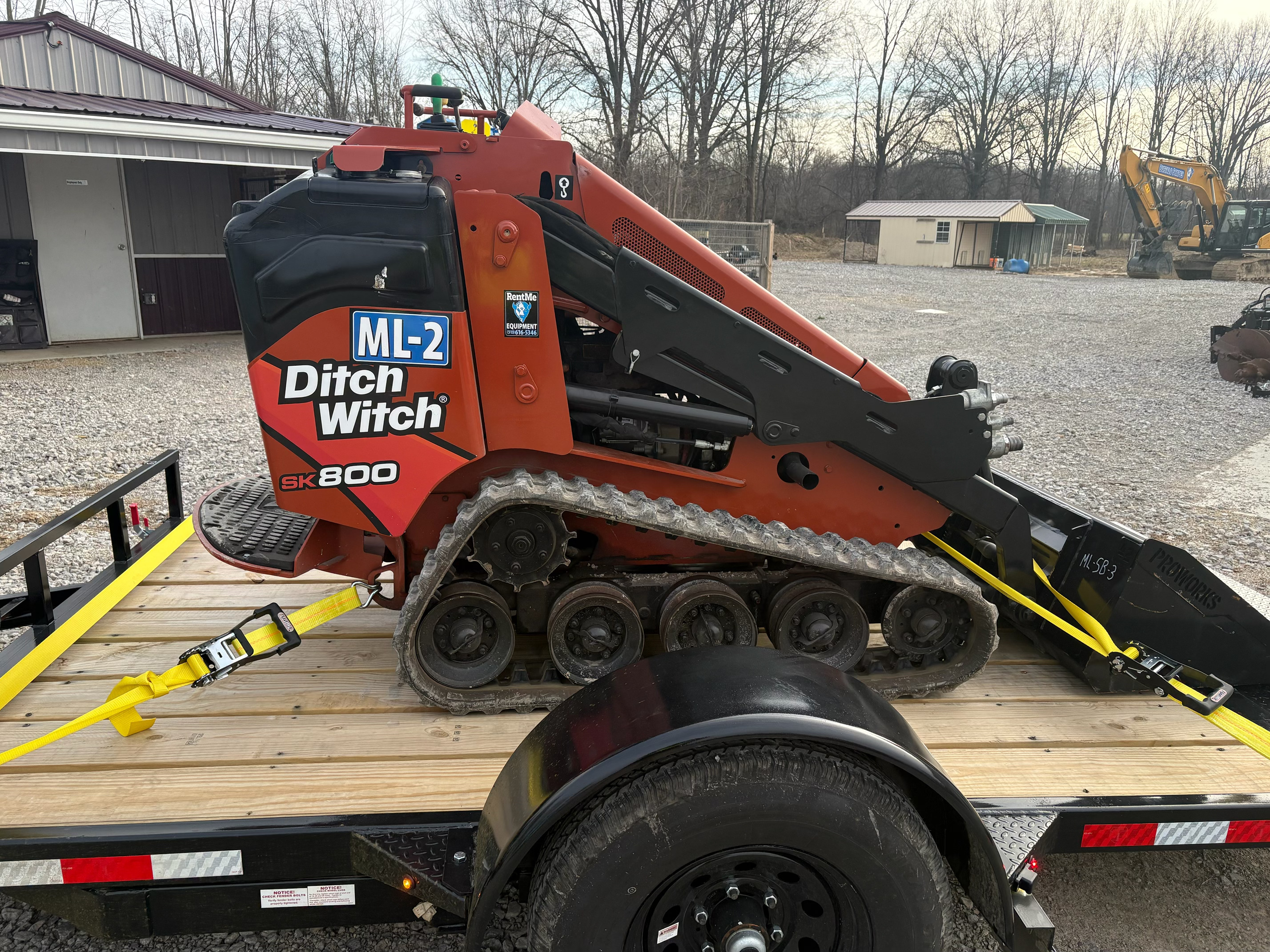 Skid steer secured on trailer for delivery to job site from RentMe Equipment in Cincinnati Ohio