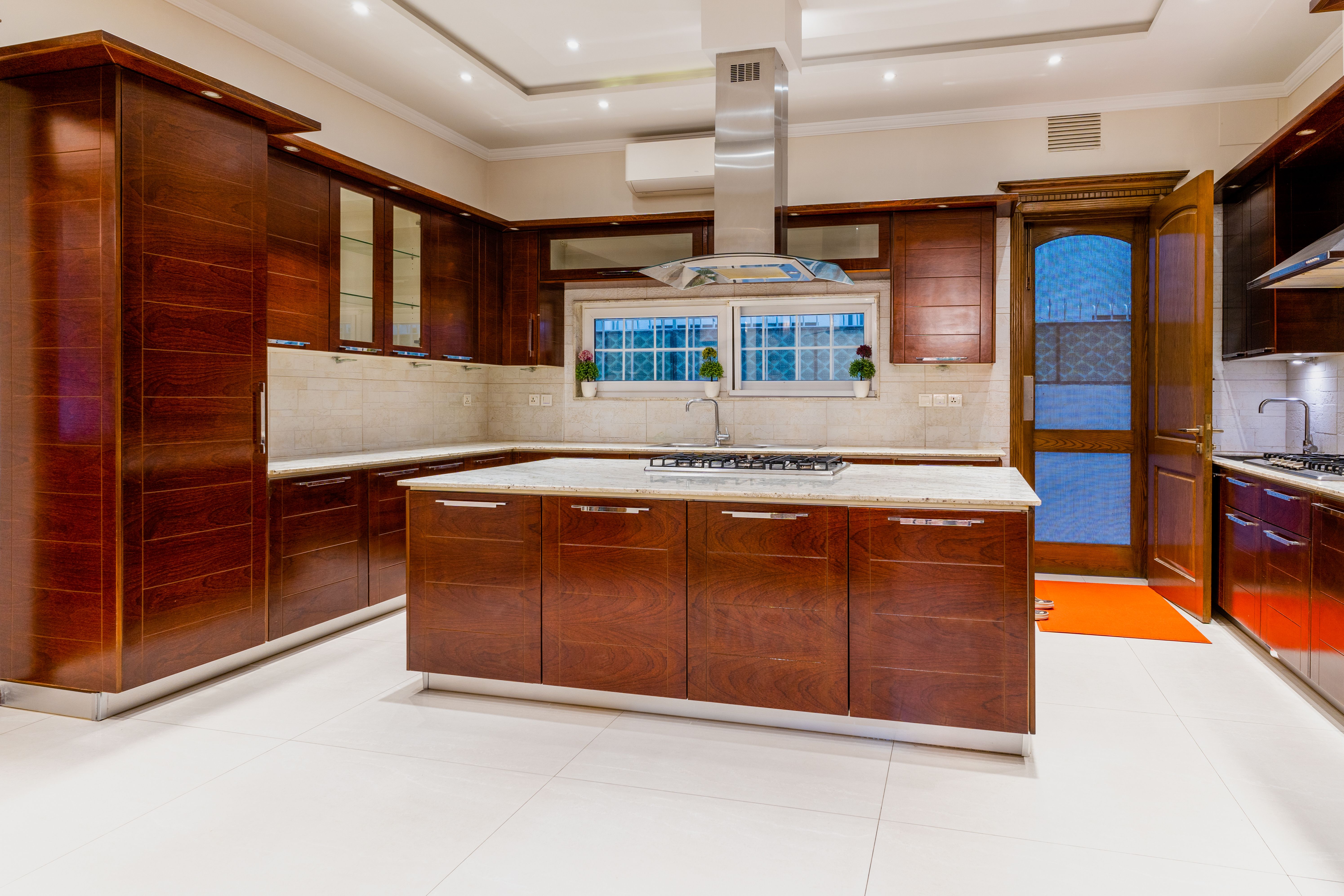 Kitchen & Bath Remodel team designing an open-concept kitchen with elegant lighting and island seating