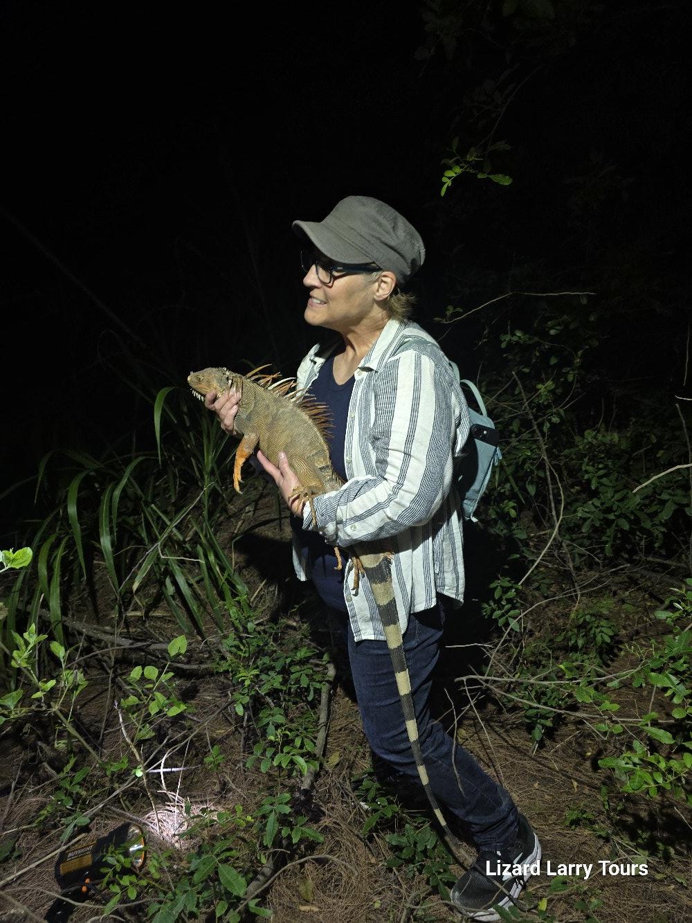 Woman holding a reptile safely during tour