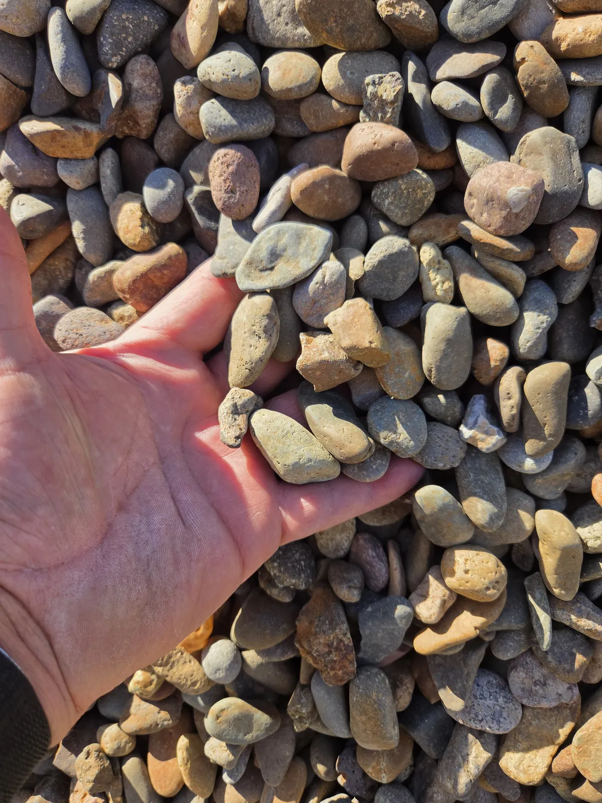 Close-up of smooth round gravel and rock delivered by WB Group