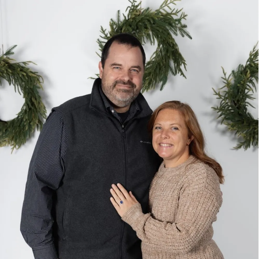Portrait of Joshua and Rachael Boyd smiling together.