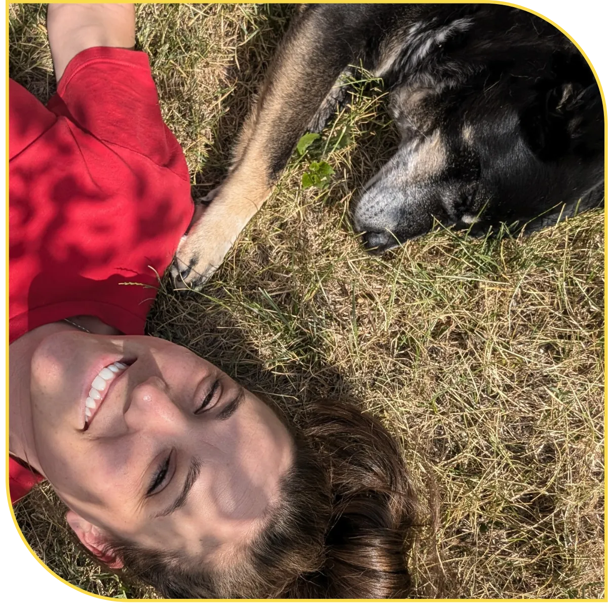 Brittany Silva laying in the grass with dog sophie