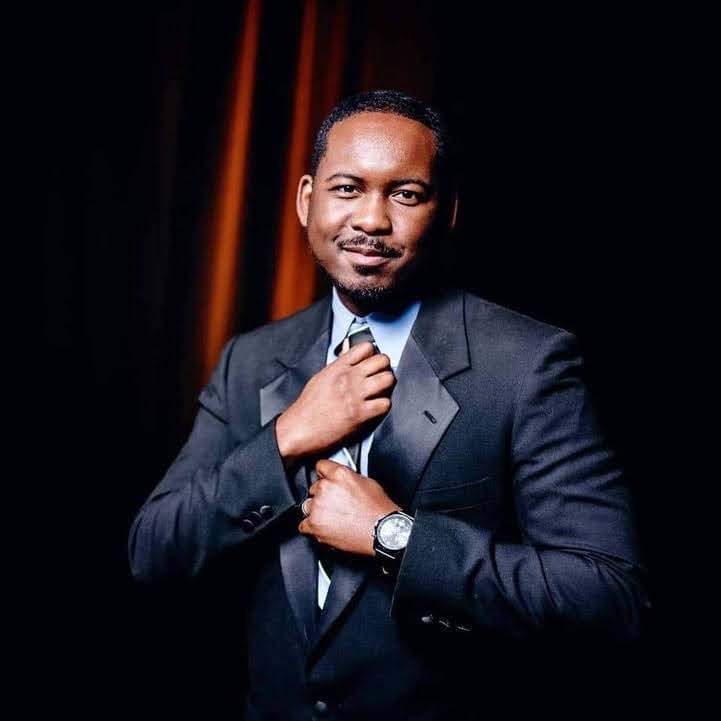 a large white barn with stairs leading up to it