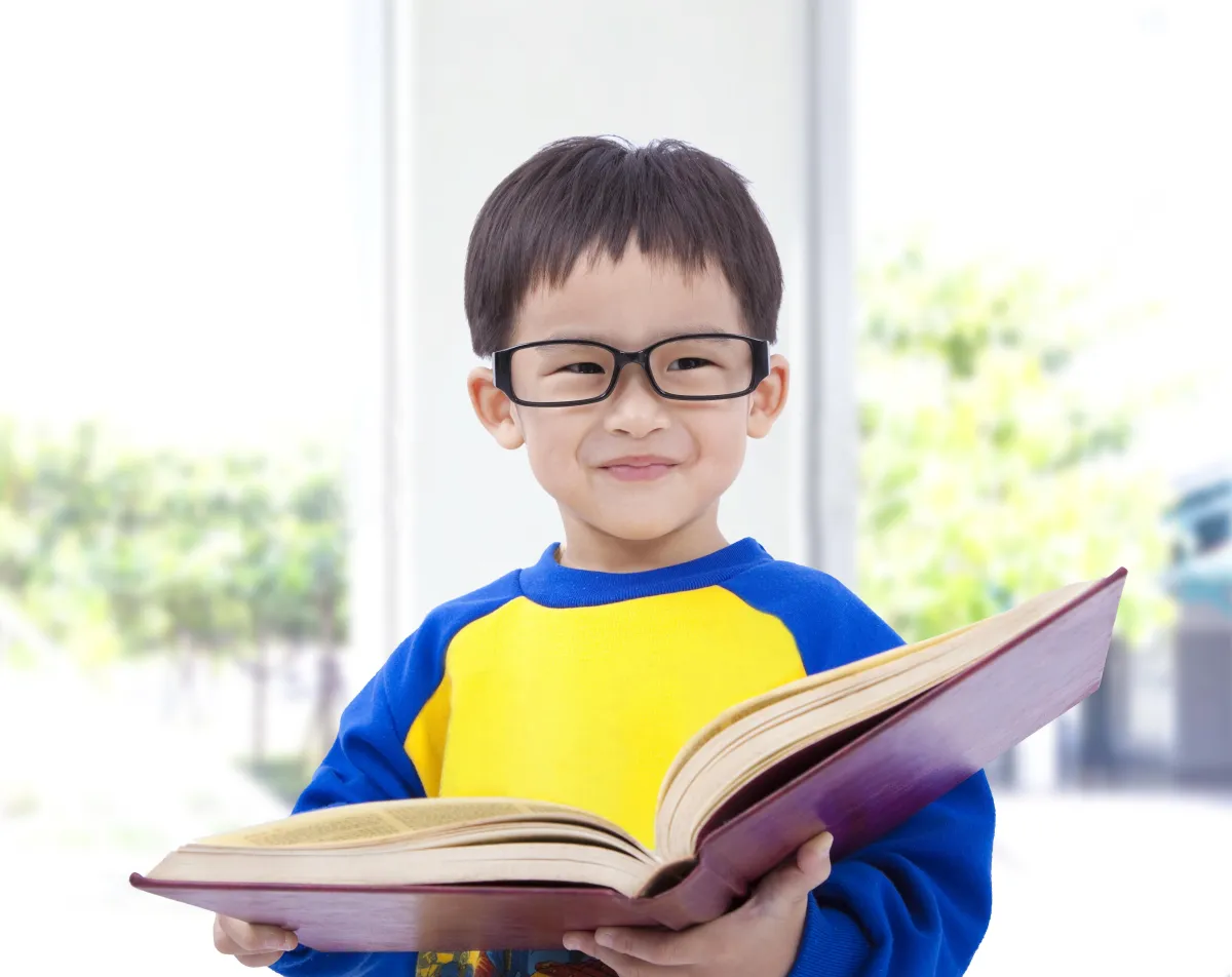 Kid is holding a book