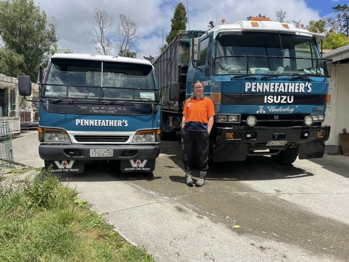 Pennefather's Contracting & Cartage trucks with team member in hi-vis, showcasing local cartage services in Wellsford, Auckland, and Northland.