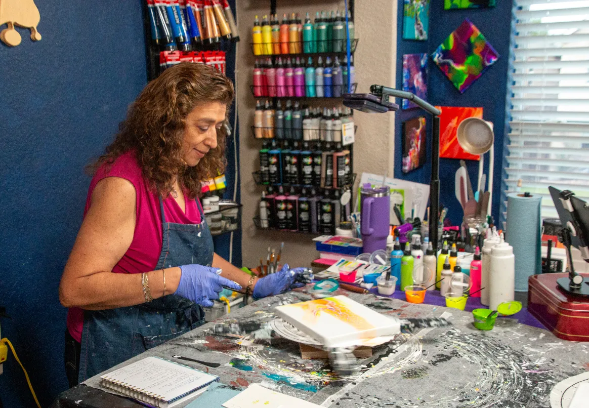 Alicia Díaz Blevins’ art studio with paints and abstract works.