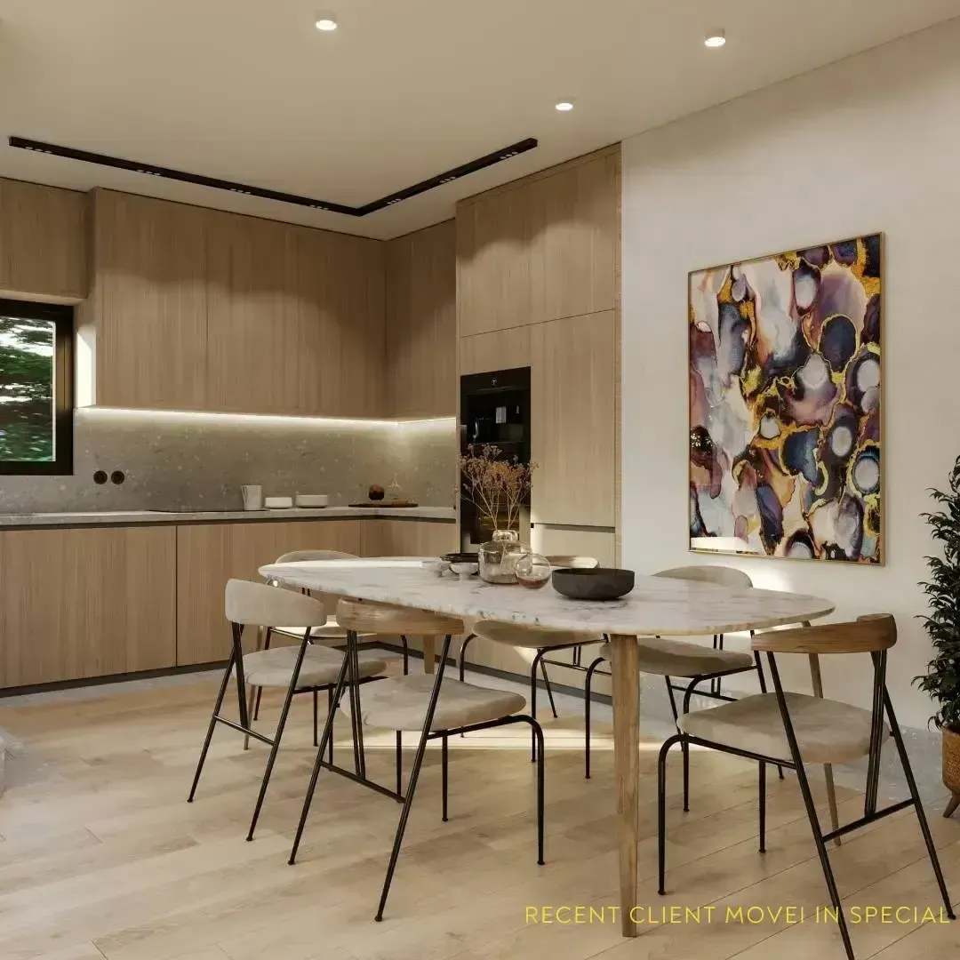Modern apartment kitchen and dining area with wood cabinetry and light wood floors.