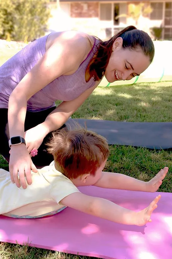 mobile physiotherapist helping young NDIS participant with movement therapy in Brisbane