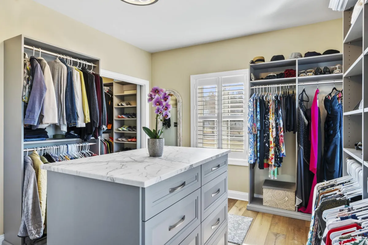 Closet with clothes organized and clean surfaces
