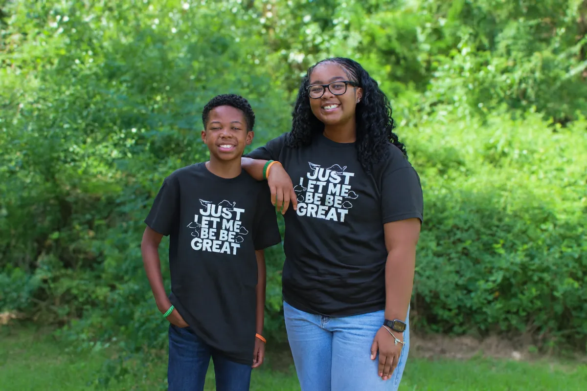 a woman in a purple dress and orange boots