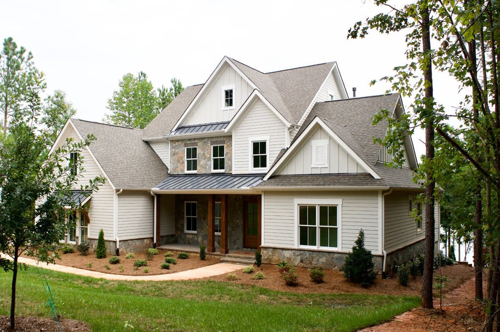 Children playing on a grassy lawn near a modern building.