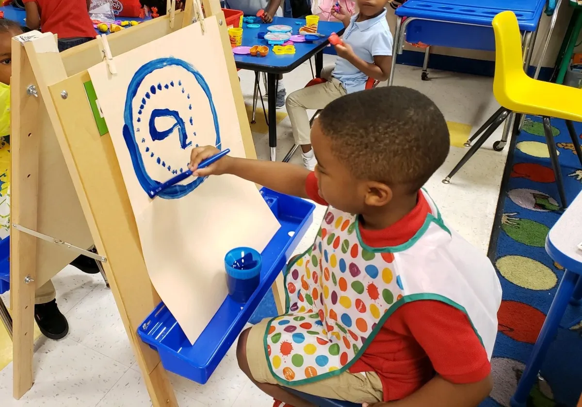 Girl follows directions during arts and crafts time.