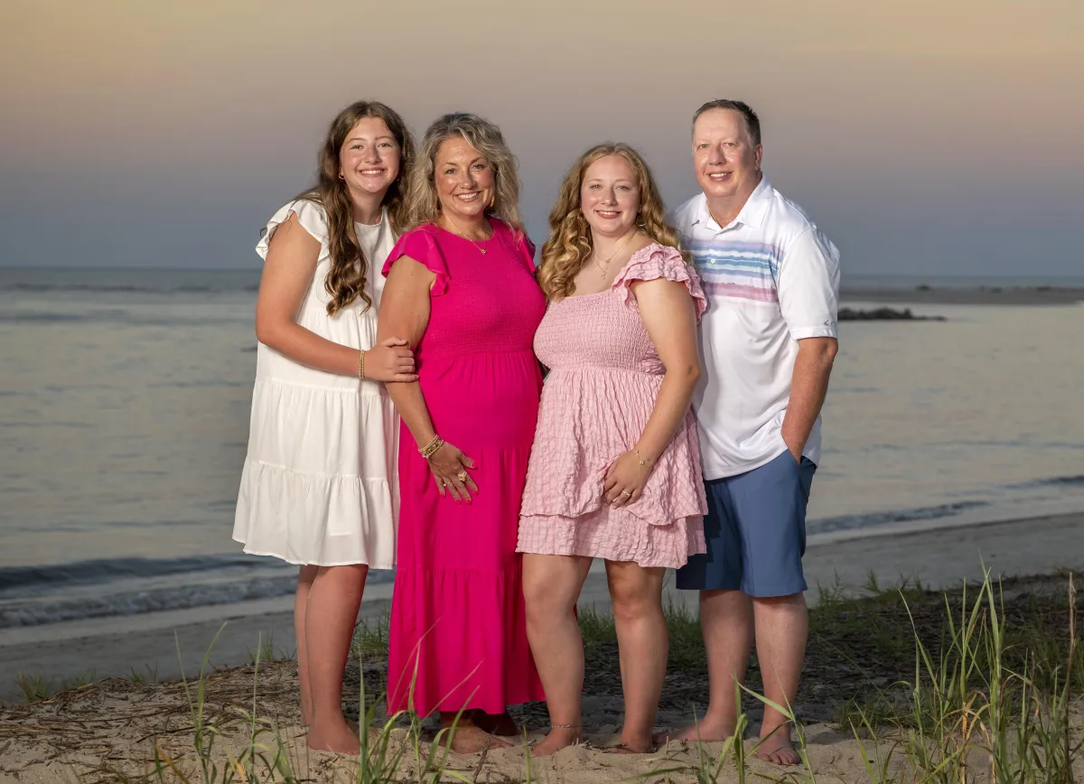 Family of four smiling during Classic beach photography session on Hilton Head Island