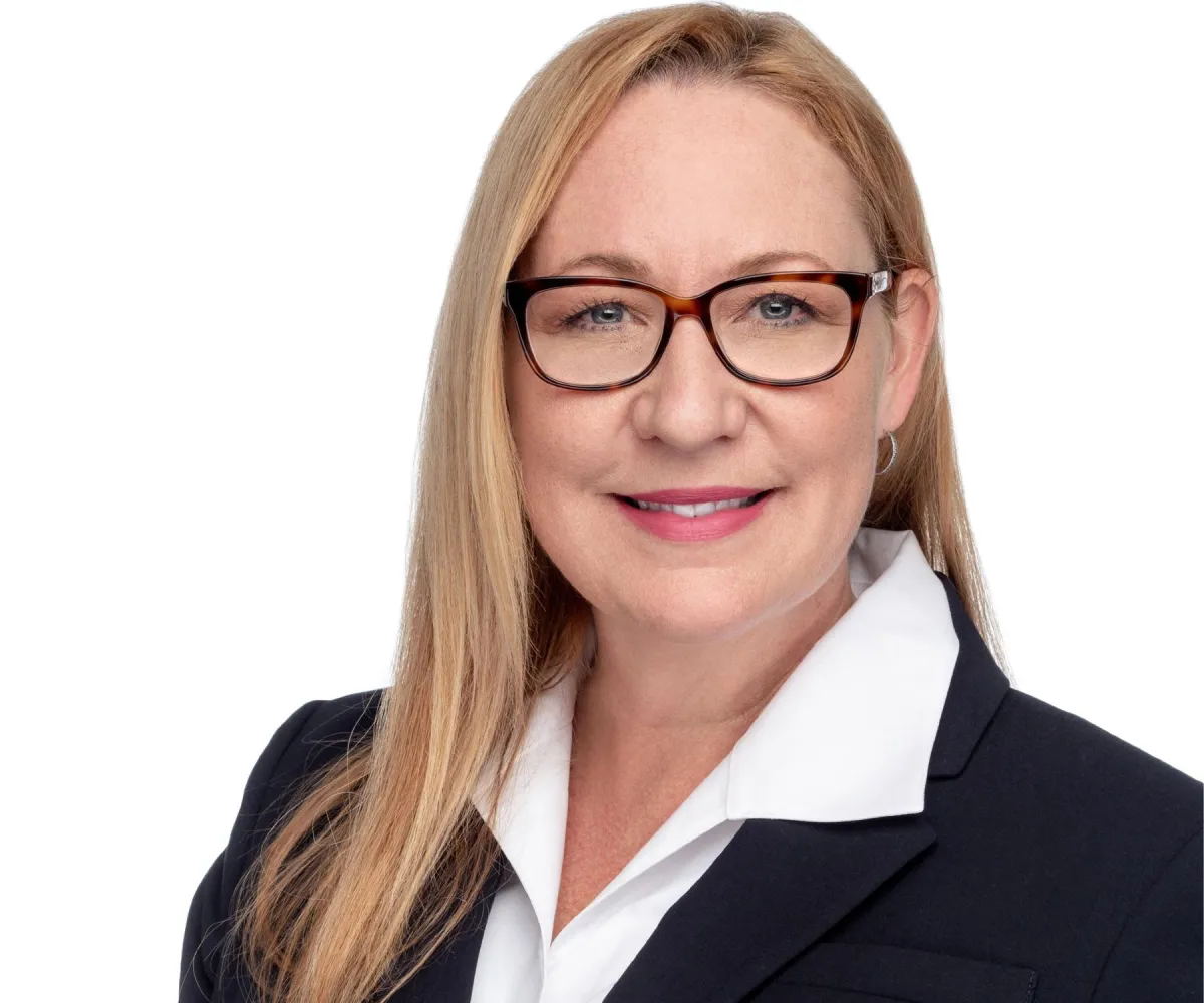 Classic business headshot on white — straight-on pose, confident posture.