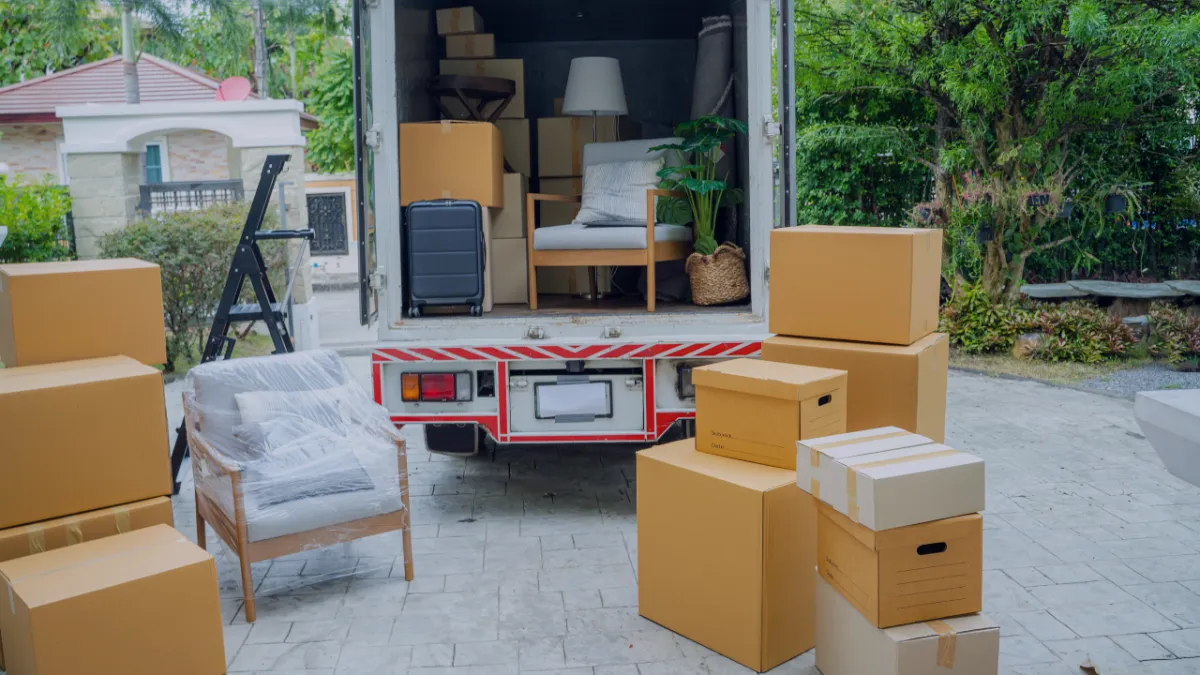 Furniture being carefully wrapped during moving service,Professional movers packing boxes for house move in Niagara Ontario