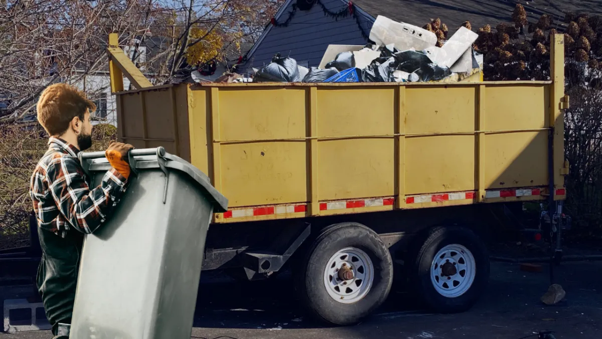 Junk removal truck clearing garage and household waste