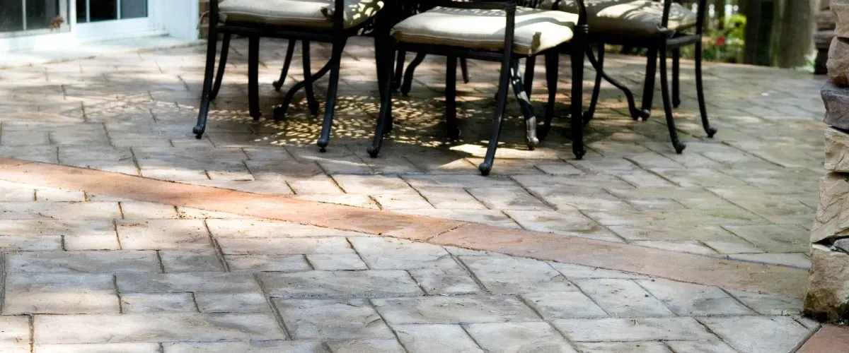 Stamped concrete patio with chairs and decorative texture