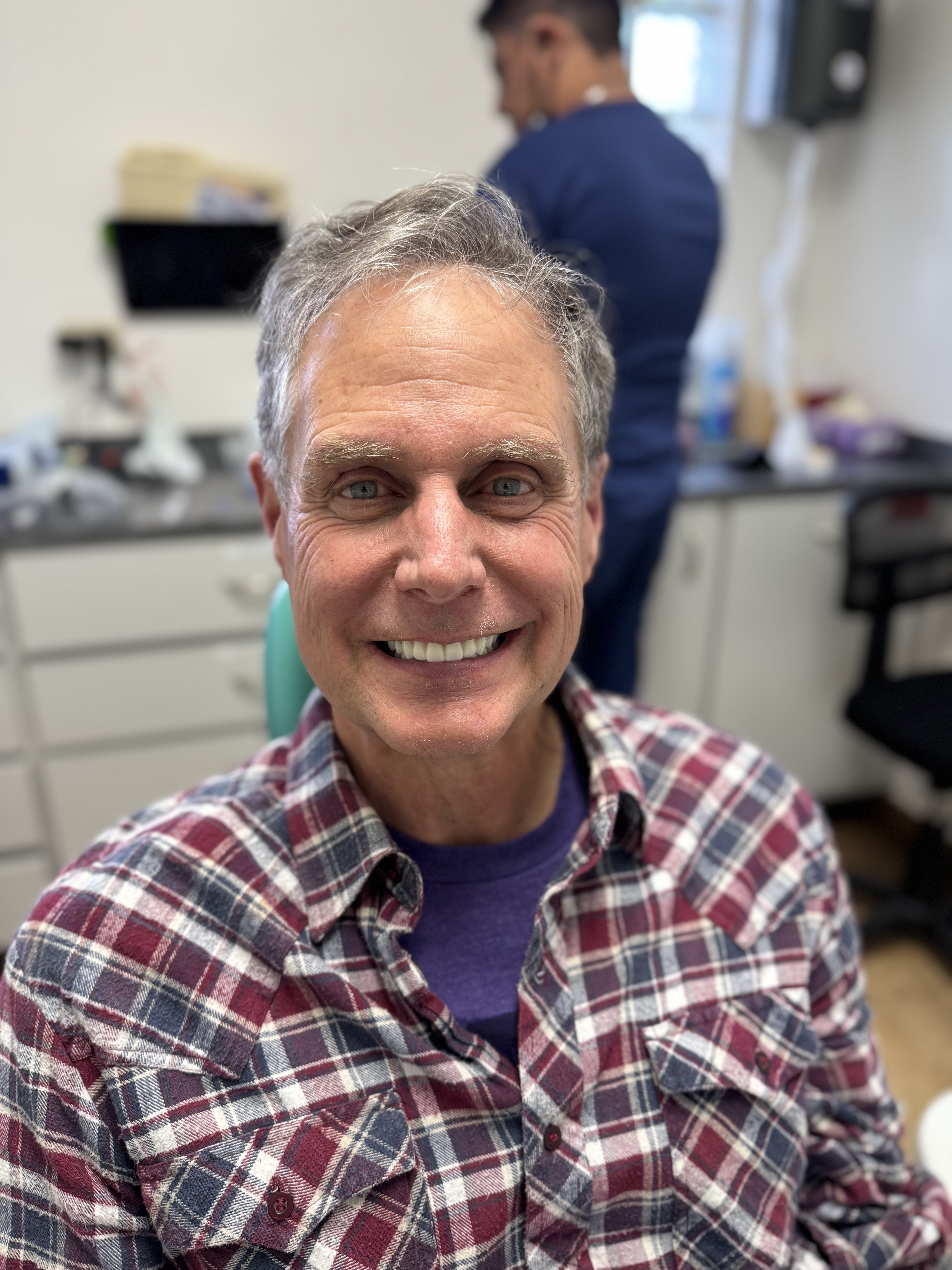 Before and after dental implant restoration split view for patient Robert M